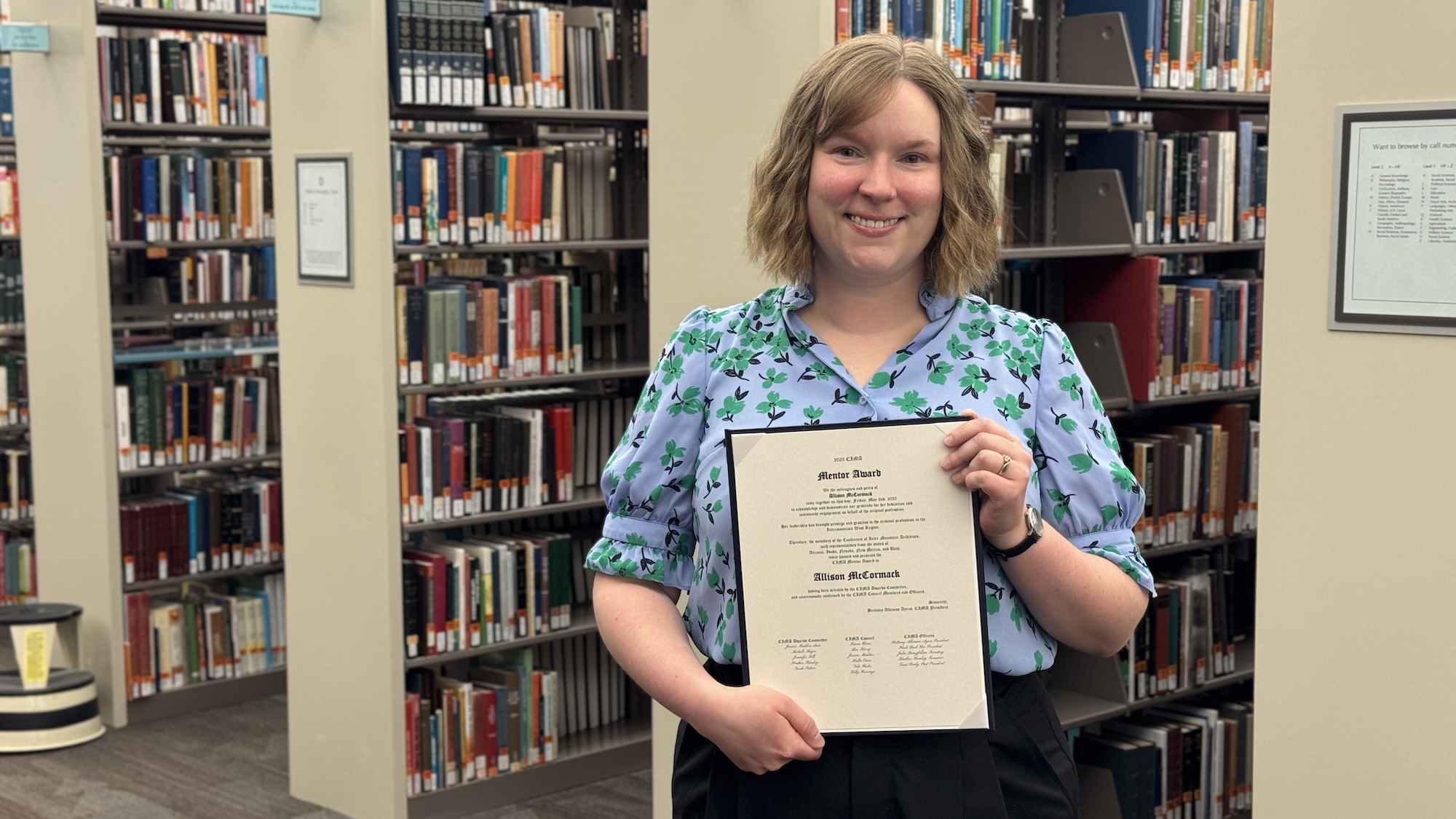 Allie McCormack poses with Award from Conference of Inter-Mountain Archivists