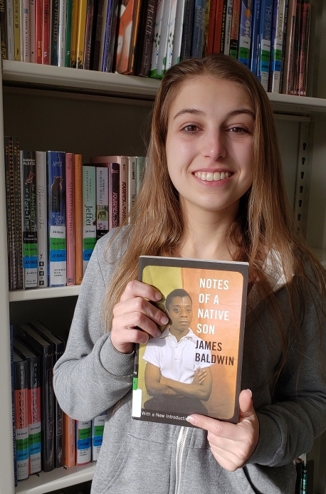 Student holding as book