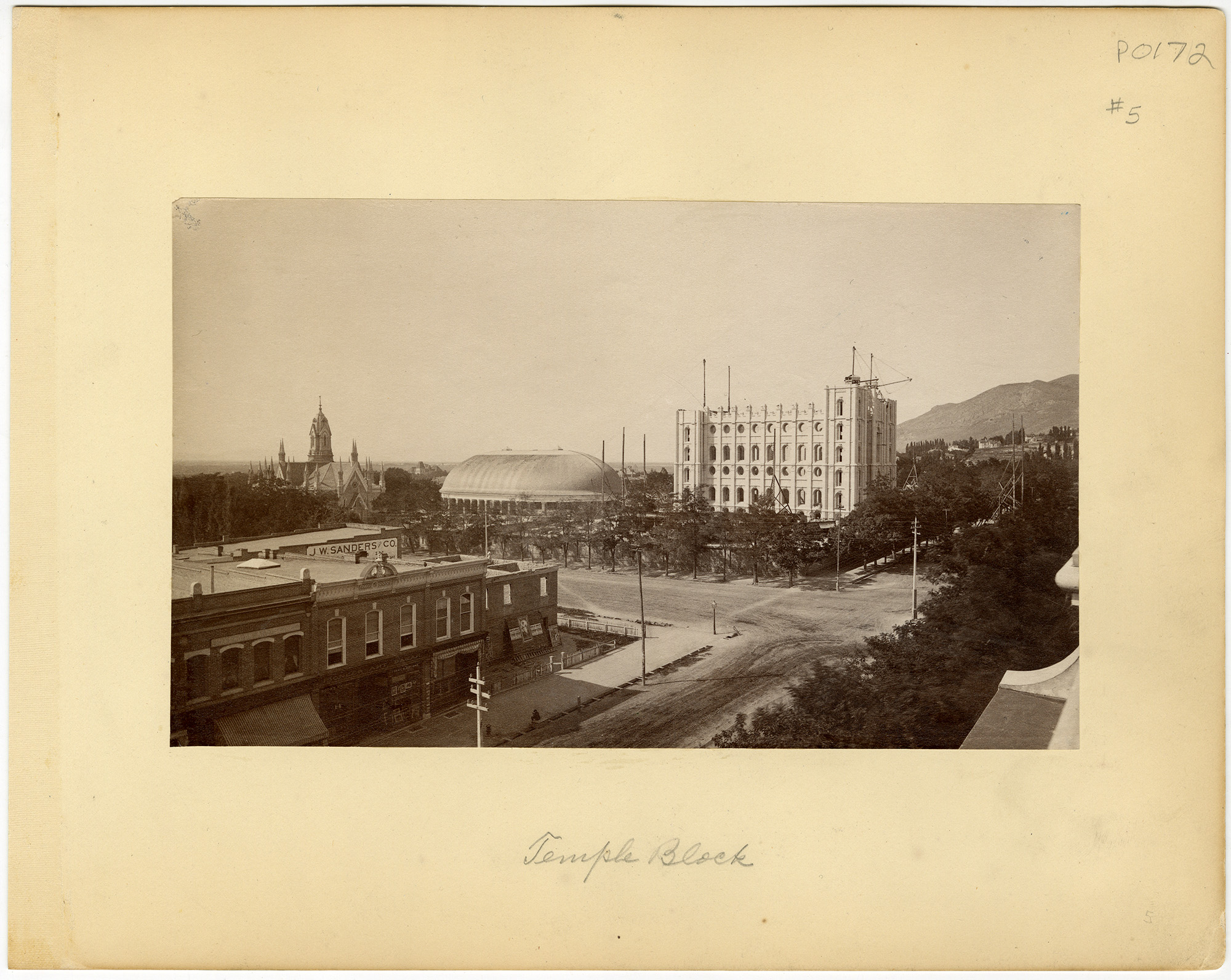 Sepia photograph of Temple Block, showing historic buildings, a domed structure, church spire, tree-lined streets, and distant hills in a quiet cityscape.