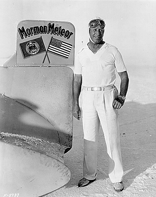 Ab Jenkins next to tail of his record seting Mormon Meteor car, 1931