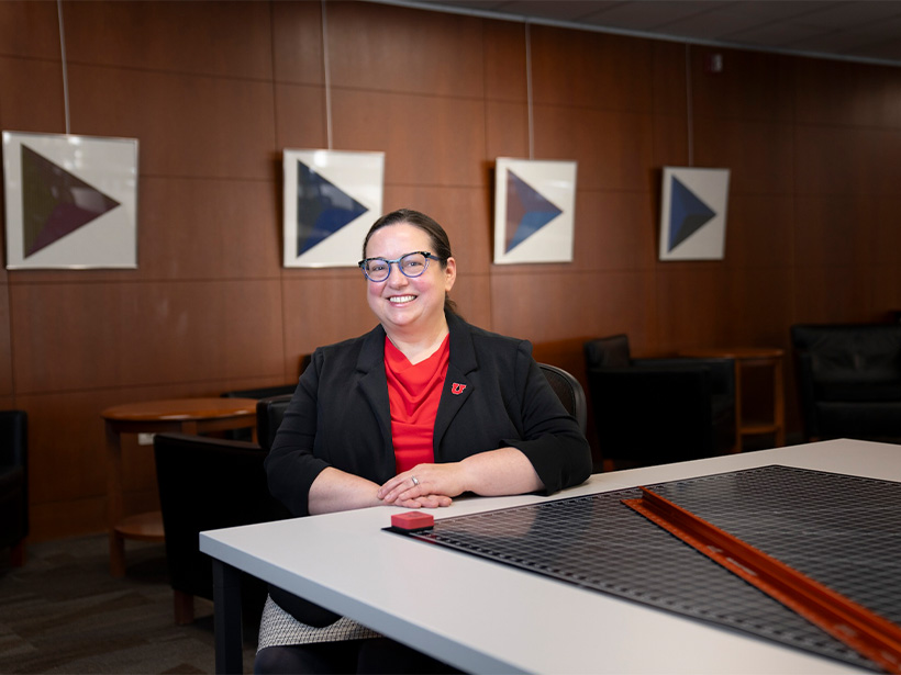 Dean Sarah Shreeves posing in front of modern artwork in the Fine Arts and Architecture Library