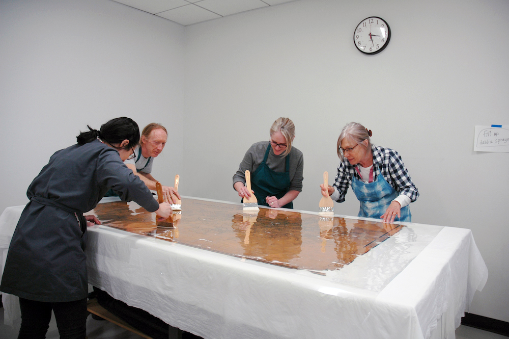 preservation staff treating a map