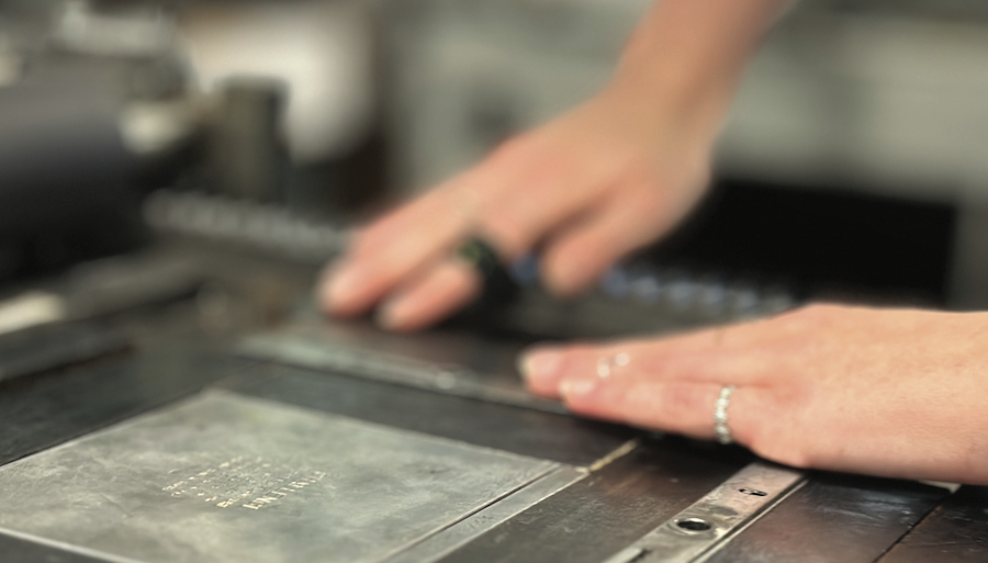 hands adjusting printing type