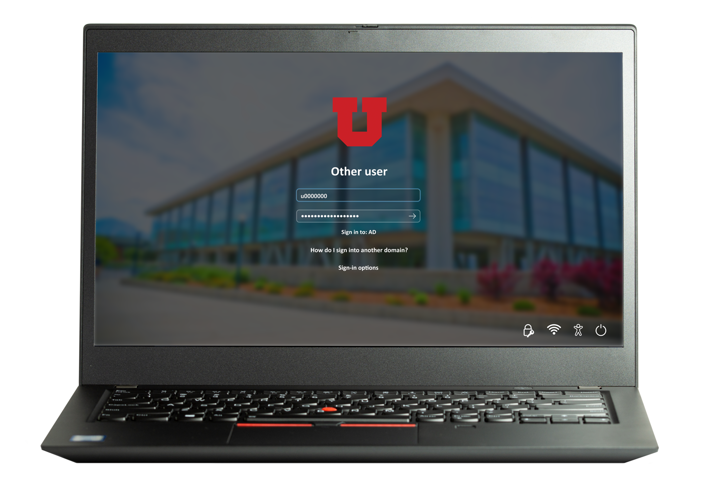 A windows laptop that shows the Marriott Library in the background of a login window. Sign in with your uNID and campus password